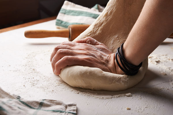 Kneading pizza dough