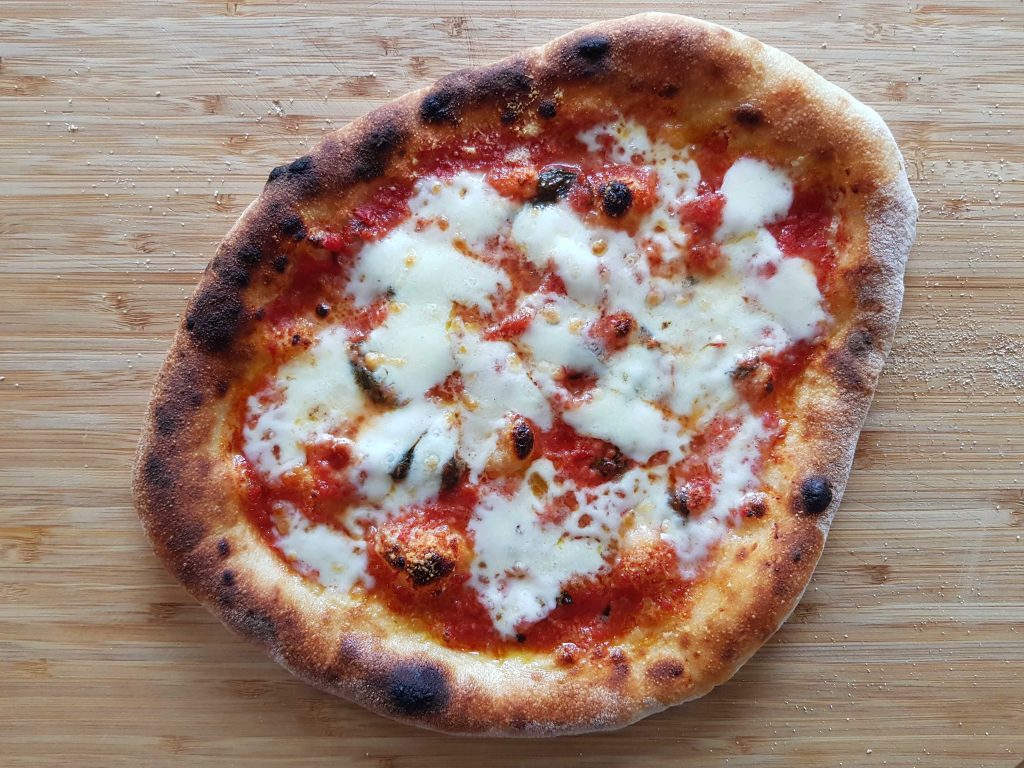 Neapolitan pizza baked on pizza steel using the broiler.