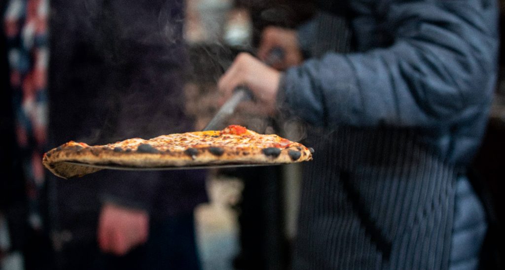 leopard pizza on perforated pizza peel