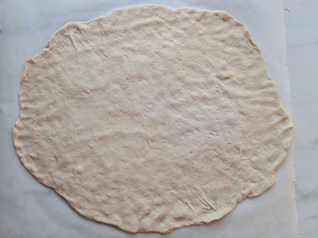 Pizza dough on paper