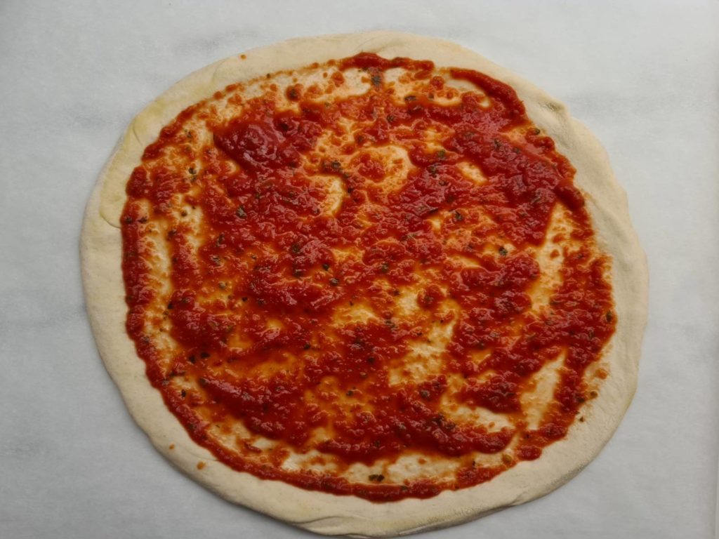 Pizza base with sauce