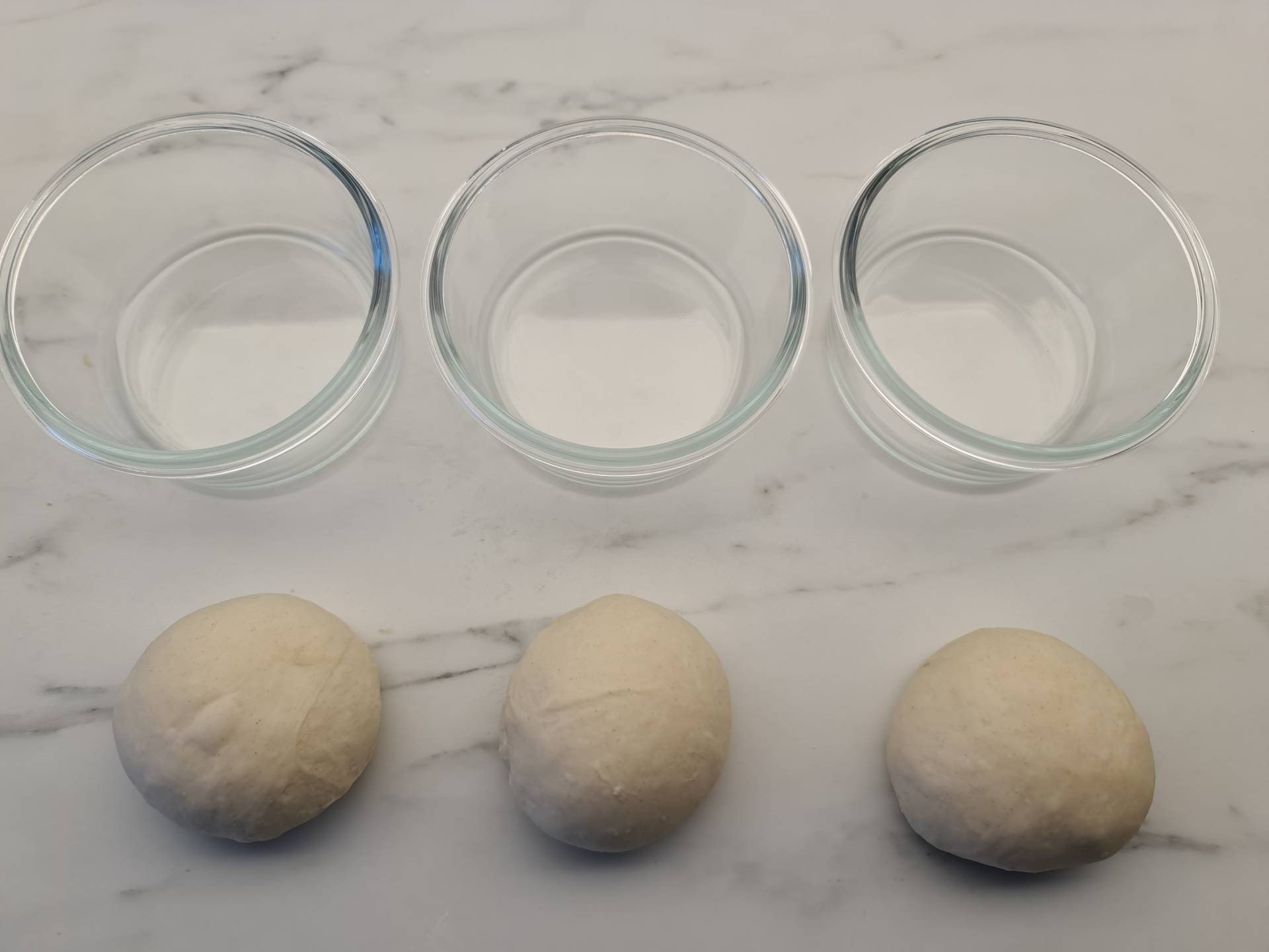3 dough ablls and pizza dough containers