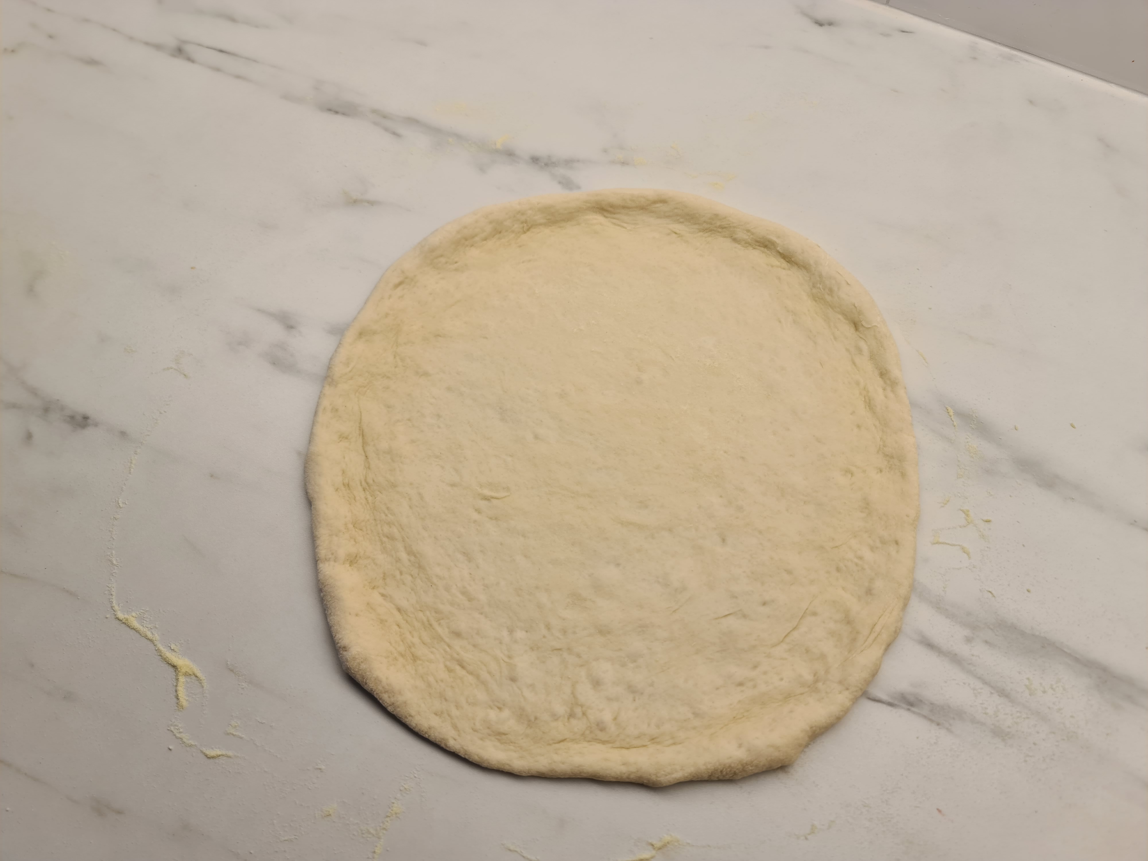 Fully stretched out pizza dough