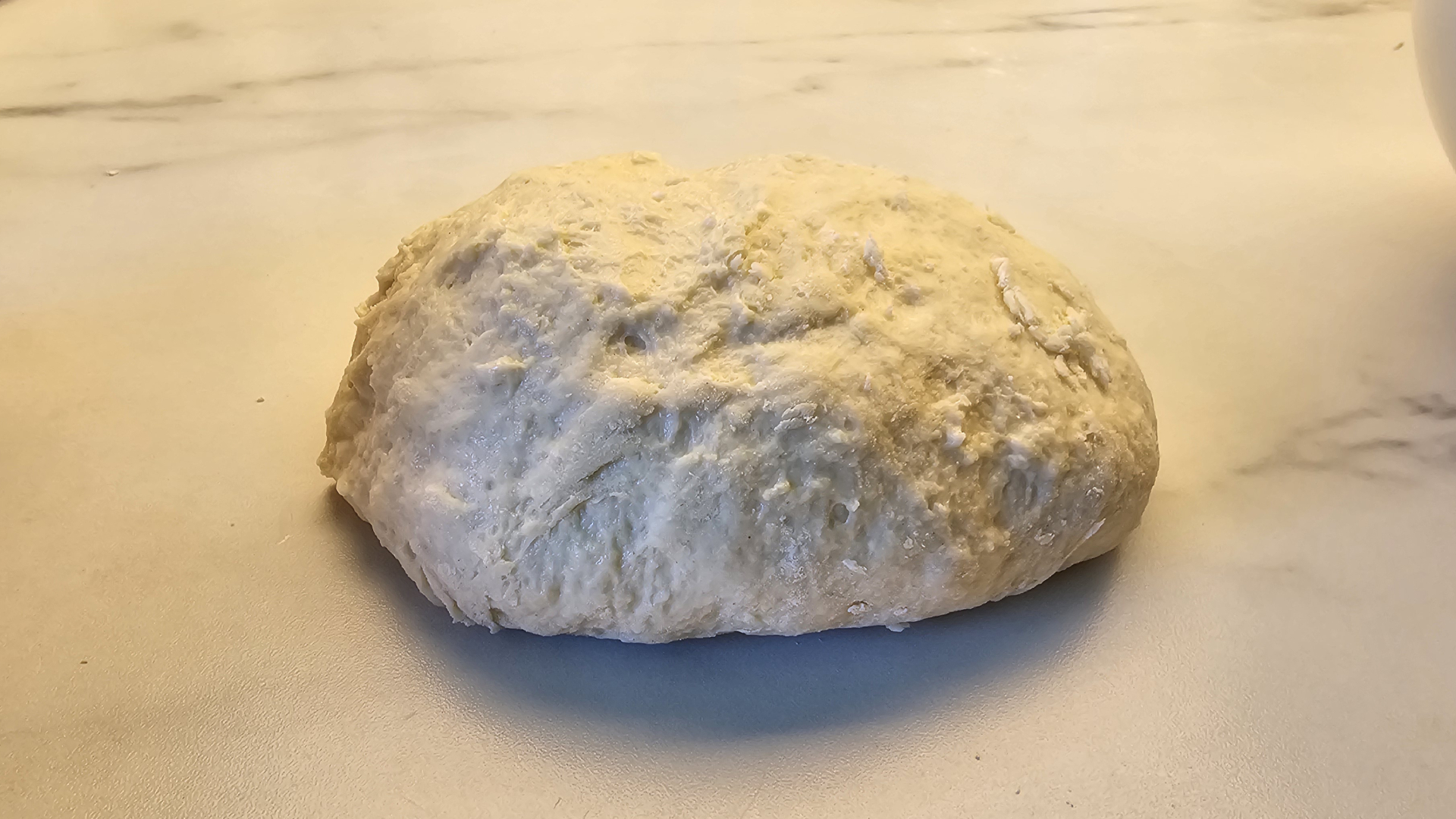 Shaggy pizza dough on a countertop